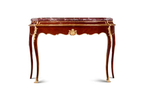 A graceful French Louis XVI style gilt-ormolu-mounted crossbanded veneer inlaid freestanding console table after the model by Francois Linke late 19th century, The fine four centimeters thickness moulded marble top above a confronting curved frieze finely framed with a foliate ormolu border in three sections above a polished ormolu band, The crossbanded veneer inlaid arbalest shaped frieze below is centered with finely chiseled gilt-ormolu-mounted foliate cartouche; the front cabriole legs are adorned with large blossoming chutes and an ormolu strip to the contour of the piece, The front legs are terminated with exquisite volute wrap around acanthus ormolu sabots